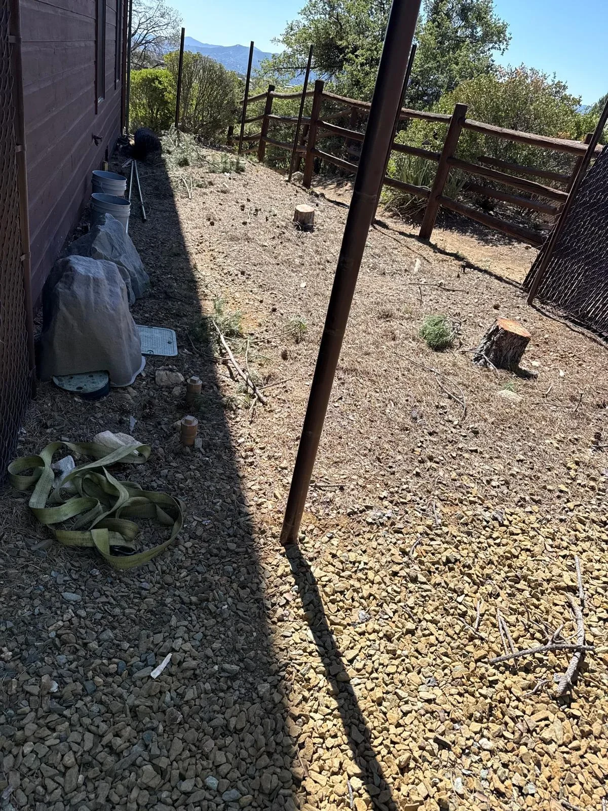 Rustic wooden corral with metal gates and gravel base in Prescott Valley